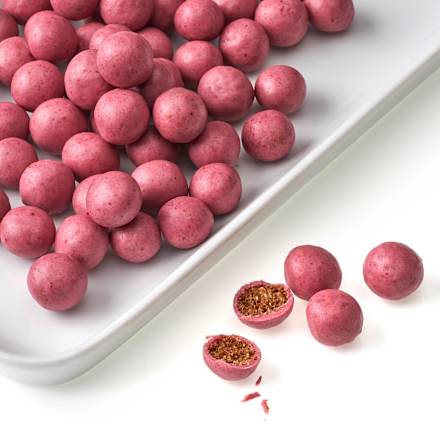 malinové křupavé kuličky v bílé čokoládě, kukuřičný extrudát dmBio